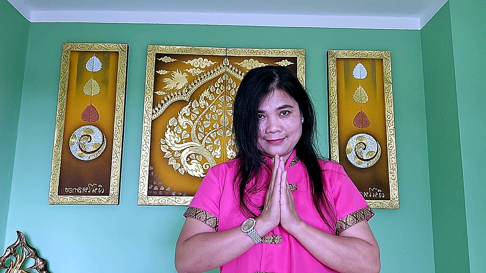 Udom, Inhaberin von UDOM MASSAGE, begrüßt Gäste mit der traditionellen Wai-Geste